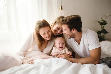 Fototapeta premium a Happy Family with a newborn baby, lying on a light bed in a very bright room