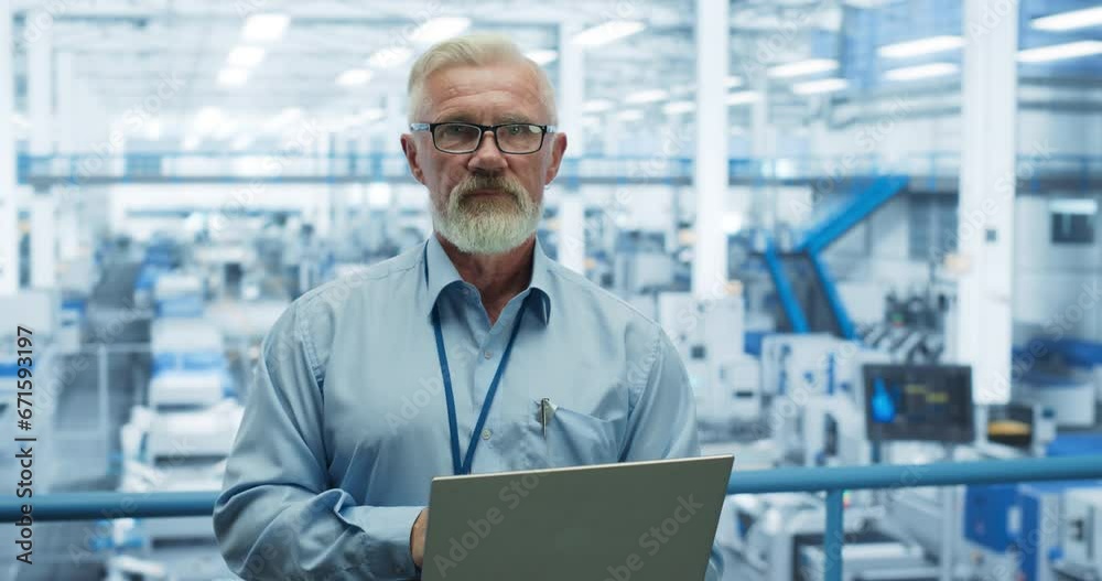 Aufkleber Portrait of a Handsome Middle Aged Engineer with a Beard and Glasses Using Laptop Computer and Looking at Camera. Male Specialist Working in a Modern Electronics Factory