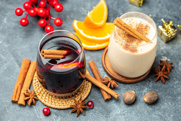 glasses of mulled wine and eggnog, Christmas winter alcohol drinks on a light background top view. copy space