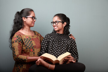 Indian ethnic affectionate mother helps the daughter in her studies