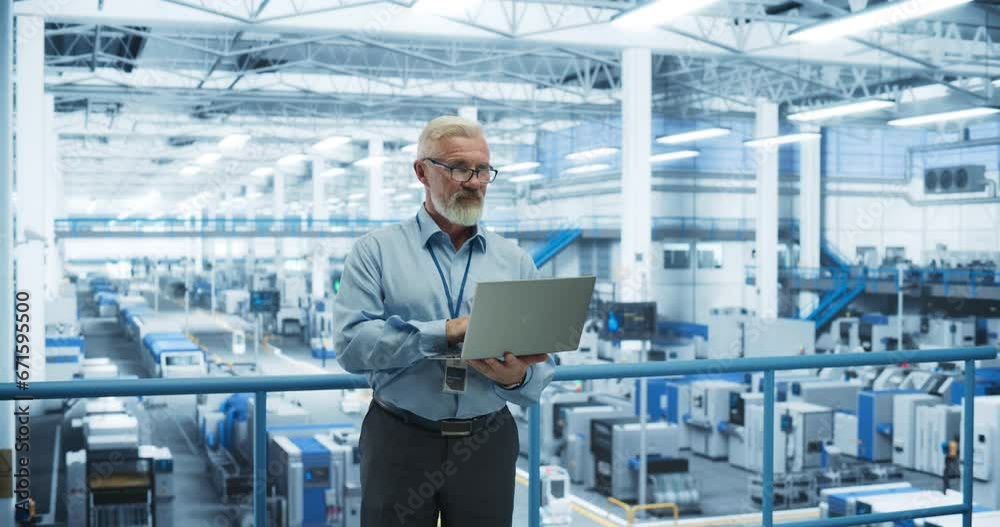 Poster Electronics Manufacturing Technician Working on a Laptop Computer at a Factory Space. Specialist Developing, Maintaining, Fine-Tuning Programs for Machine Production and Assembly