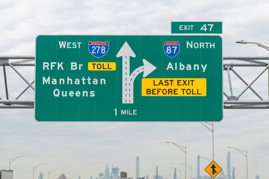 Interstate and directional signs to I-278 West RFK Bridge, Manhattan, Queens and I-87 North Albany, last exit before toll  exit 47 in direction of New York City, NY, USA, skyline vague in background