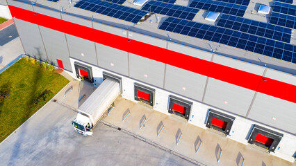Industry with low carbon footprint. Industrial warehouses with solar panels on the roof. Technology park and factories from above.
- 671597723