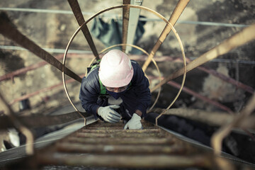 Male climb the stairway storage visual inspection tank