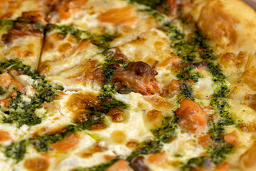 Obraz na płótnie Canvas pizza with red trout fish and green sauce food and seafood