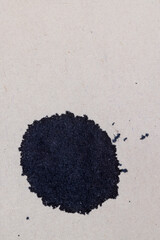 grey recycled paper with black ink drops