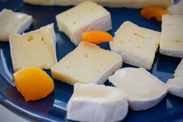 Close-up, selective focus on the cheese, emphasizing the luxury and tastiness of this restaurant-quality meal. The soft and creamy texture of Brie and Camembert cheeses creating tasty flavor.