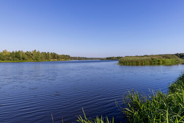 a wide river in sunny weather in early autumn
