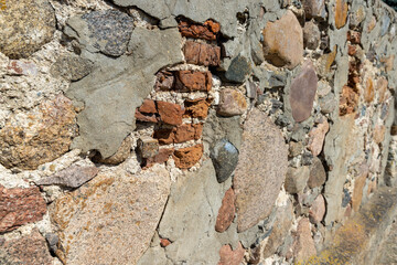 ancient wall of cobblestones and red bricks