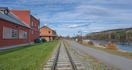 Fototapeta premium Railroad tracks and hiking trail beside the Yukon River at Whitehorse, Yukon, Canada