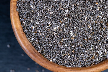 raw chia seeds rich in vitamins and minerals , wooden bowl