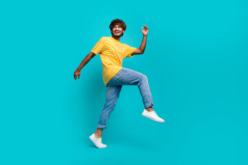 Fototapeta na wymiar Full size portrait of positive nice person walk look empty space advert isolated on turquoise color background
