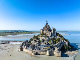 Aerial view Mont-Saint-Michel monastery and abbey, Le Mont-Saint-Michel, salt marshes, Normandy, France - obrazy, fototapety, plakaty