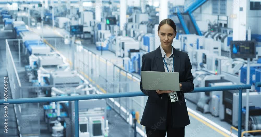 Poster Portrait of a Beautiful Happy Engineer Using Laptop Computer and Looking Around a Factory Facility with Automated Robotic Arms Producing Modern Electronic Components for Different Industries
