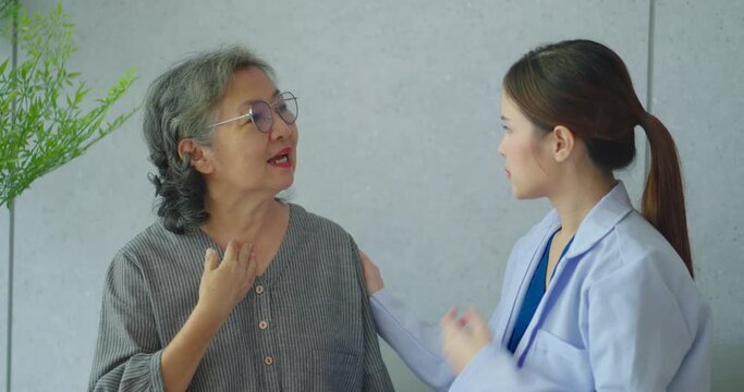 Senior woman talking with female nurse at hospital. Nurse makes an appointment with a senior woman at the hospital.