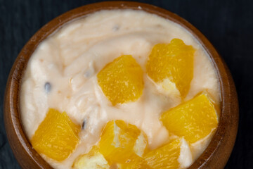 pineapple yogurt with slices of ripe yellow orange