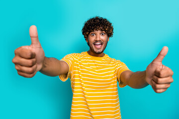 Photo portrait of nice young male show excited thumb up wear trendy striped yellow garment isolated...