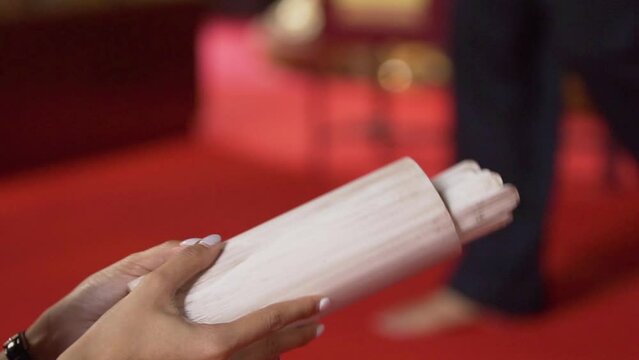 woman's hand shakes a wooden fortune telling numbers on it.