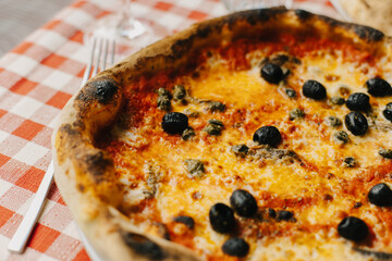 Delicious pizza Margarita in a traditional Italian pizzeria.