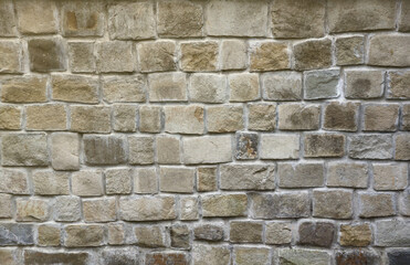 Texture of old grey stone wall with various stones.