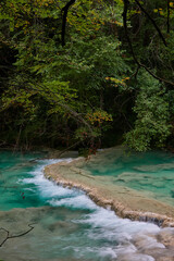 The waterfalls and crystal clear, blue, turquoise and green waters of the Nacedero del Urederra, with its beech forest with its autumn colors in the Sierra de Urbasa-And&iacute;a. Navarre. Spain
