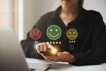 customer satisfaction survey concept businesswoman use smartphone Touch the happy smiley icon....
