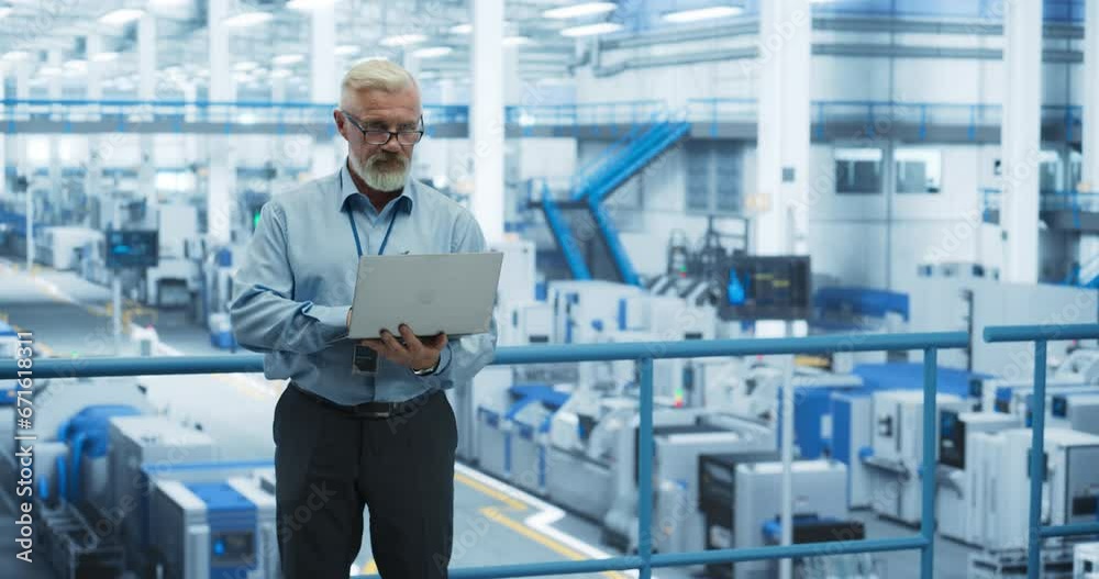 Aufkleber Senior Factory Manager Working on Laptop at a Futuristic Industrial Manufacture with Autonomous AI Robots. Specialist Monitoring All the Data on a Computer, Checking Reports and Planning Workload
