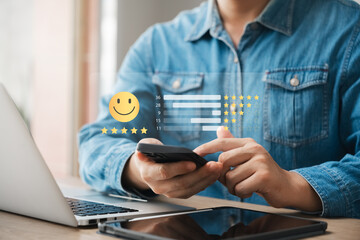 Obraz na płótnie Canvas customer satisfaction survey concept business people use smartphone Touch the happy smiley icon. Satisfied. 5 stars. Service experience rating. online application Satisfaction Review best quality.