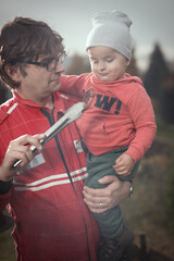Little boy with his father playing as a craftsman and gardener in autumn