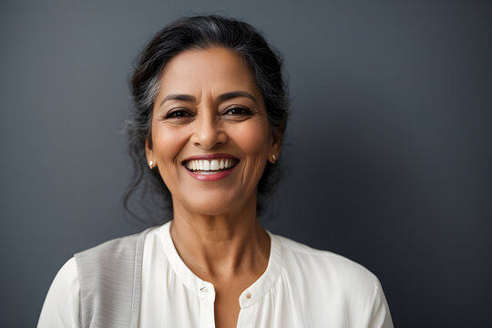 Portrait Of Smiling Middle-aged Woman With Curly Hair On Black Background