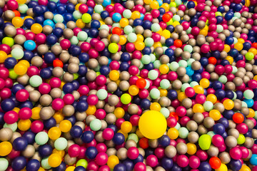 Fototapeta na wymiar Soft plastic balls in children's playroom protect children from injury.