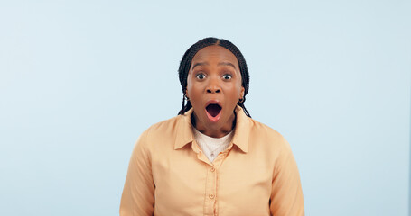 Portrait, black woman and surprised in studio, shocked or wow emoji for gossip, drama or announcement. Person, face and omg emotion for notification, news or overwhelmed on blue background or mockup