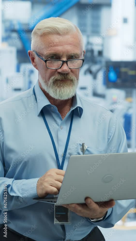 Fototapete Vertical Screen: Portrait of a Middle Aged Engineer Monitoring and Analyzing Conditions at a Modern Electronics Factory with Automated Robots Working with the Help of Artificial Intelligence Software