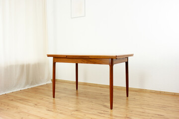 Fototapeta premium A mid century teak dining table with four chairs from the 50s 60s Danish Design Vintage Dining solid wood Modern antique 50s 60s isolated on white wall in modern living room closeup side front view
