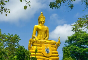 Golden Buddha statue next to statue of Big Buddha in Phuket, Tha