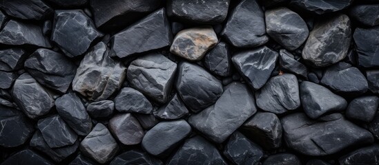 Texture and background of stones A textured background with cracked black rocks can be utilized