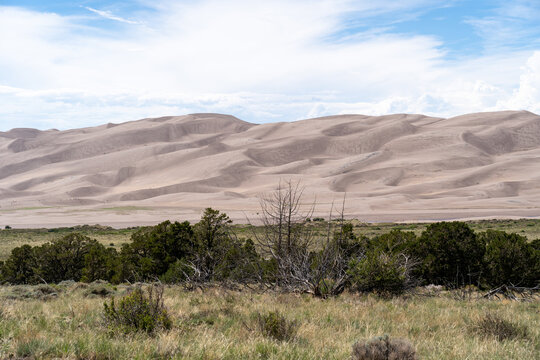 Great Sand Dunes National Park in Colorado on a sunny summer day, with mountains in the background