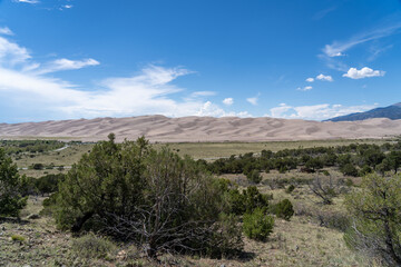 Great Sand Dunes National Park in Colorado on a sunny summer day, with mountains in the background