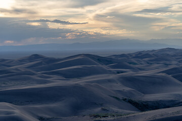 View from the top at golden hour and sunset at Great Sand Dunes National Park in Colorado on a...