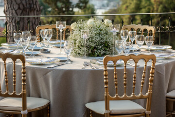 A luxurious, elegantly decorated wedding venue with a sea-view outdoor area. The decoration of the...