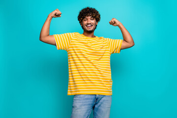 Photo portrait of nice young male sportive show biceps wear trendy striped yellow garment isolated...