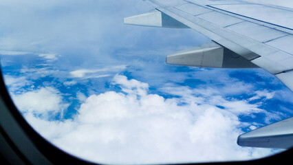 Scenic aerial view of clouds through an airplane window