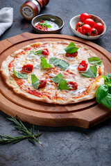 Pizza with strachatella, dried tomatoes and basil. Italian pizza with Stracciatella cheese