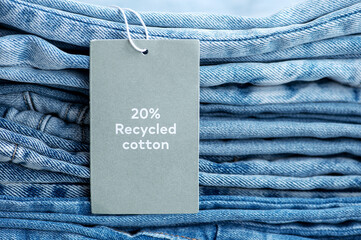 Stack of jeans with 20% discount label ,closeup
