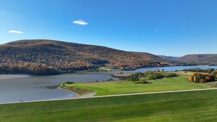 Fototapeta premium Landscape aerial with mountains and water creeks and lakes in Autumn Fall colors in Pennsylvania at Tioga