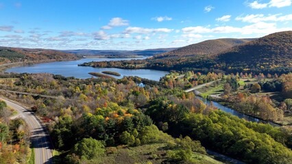 Fototapeta na wymiar Landscape aerial with mountains and water creeks and lakes in Autumn Fall colors in Pennsylvania at Tioga