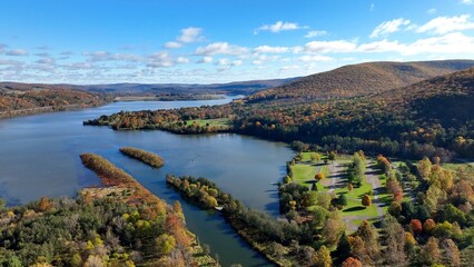 Fototapeta premium Landscape aerial with mountains and water creeks and lakes in Autumn Fall colors in Pennsylvania at Tioga