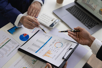 professional businessman Group of confident young businessmen analyze data using computer in a collaborative meeting discussing financial data analysis and business strategy project.