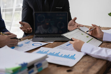 professional businessman Group of confident young businessmen analyze data using computer in a collaborative meeting discussing financial data analysis and business strategy project.