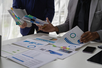 professional businessman Group of confident young businessmen analyze data using computer in a collaborative meeting discussing financial data analysis and business strategy project.